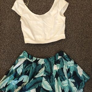 White crop top and green shorts that flare out